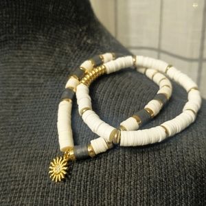 VINTAGE BLACK & WHITE  STRETCH BRACELET WITH GOLD PLATED SUN CHARM